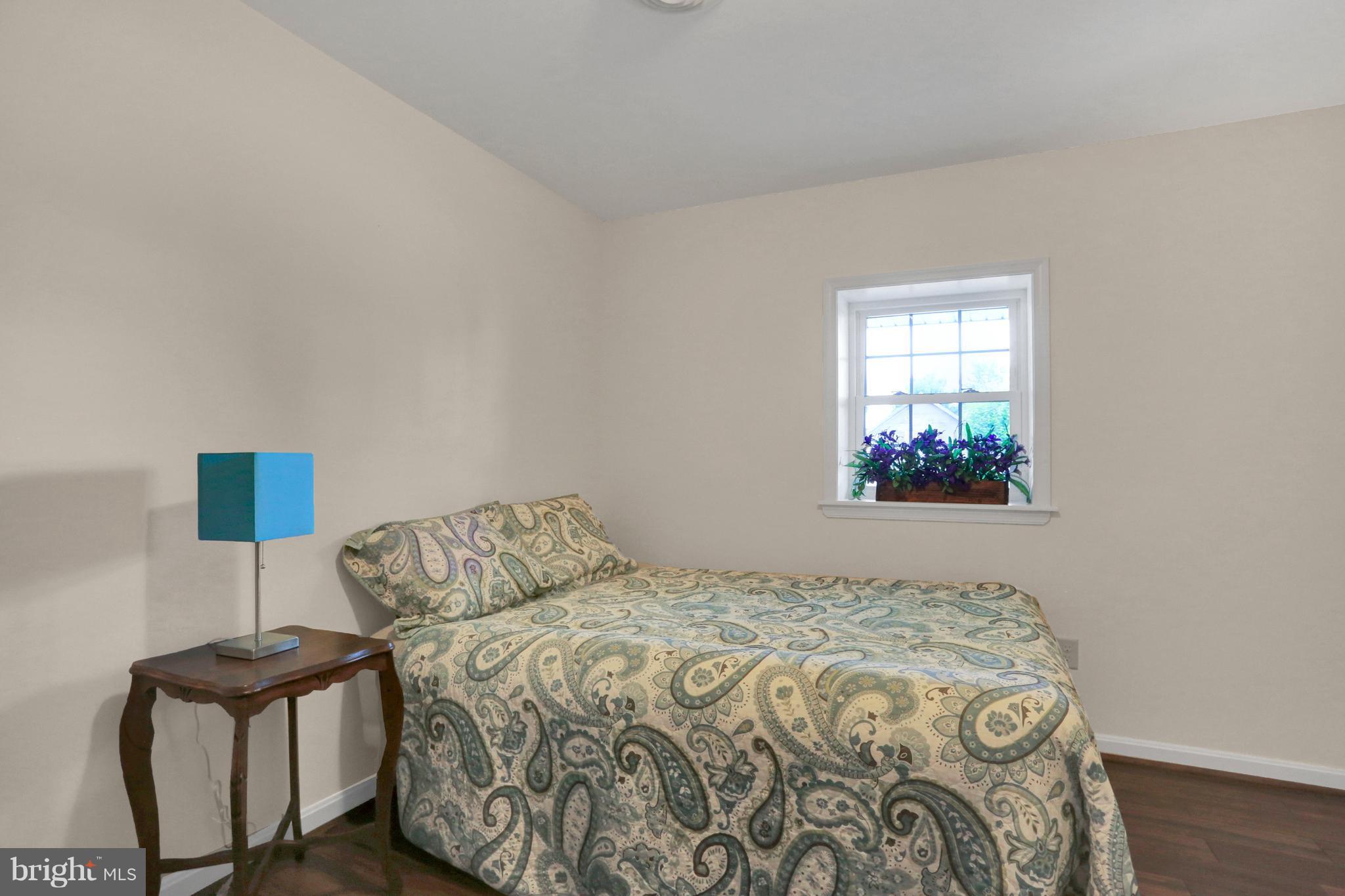 14809 Clear Spring Road Williamsport, MD 21795 - Photo 10 of 27 a bedroom with a bed and a lamp on dresser