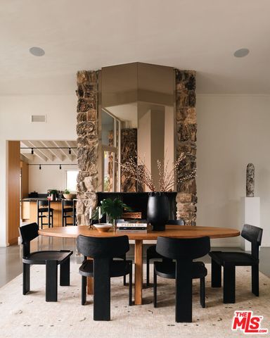 a living room with furniture a piano and a table