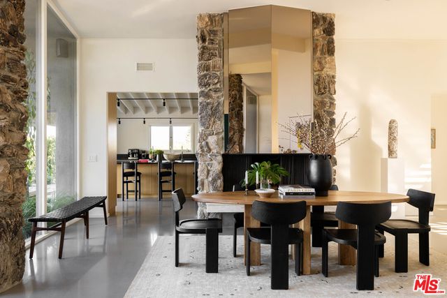 a view of a dining room with furniture and chandelier