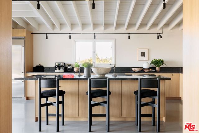 a kitchen with a sink cabinets and window
