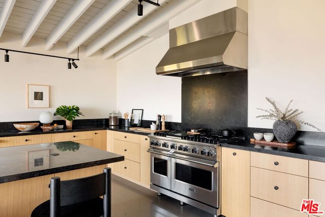 a kitchen with a stove and a white cabinets