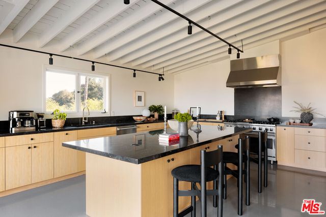 a kitchen with stainless steel appliances granite countertop a sink and cabinets