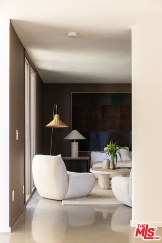 a bedroom with furniture and a large window