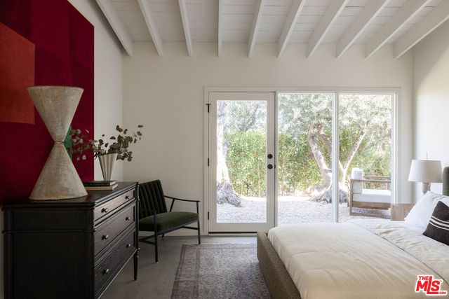 a bedroom with a large bed and a large window