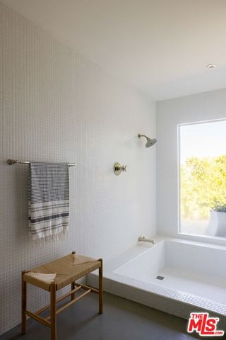 a bathroom with a sink toilet shower and mirror