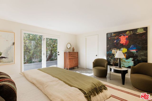 a view of a porch with a table and chairs