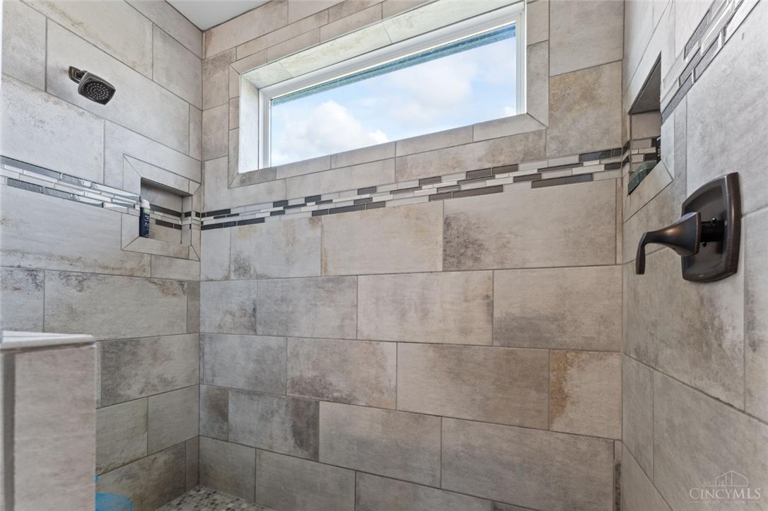 2425 Middleboro Road Clarksville, OH 45113 - Photo 72 of 91 This tiled shower includes a window and built-in niches for convenience.
