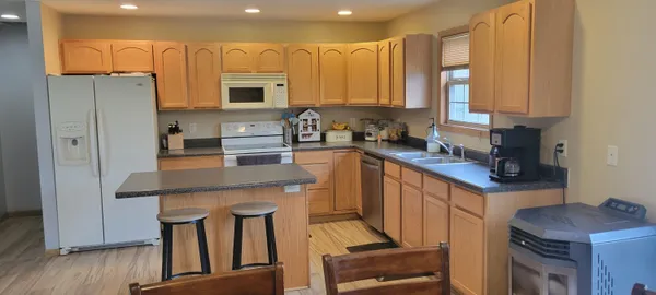 a kitchen with stainless steel appliances granite countertop a sink stove and cabinets