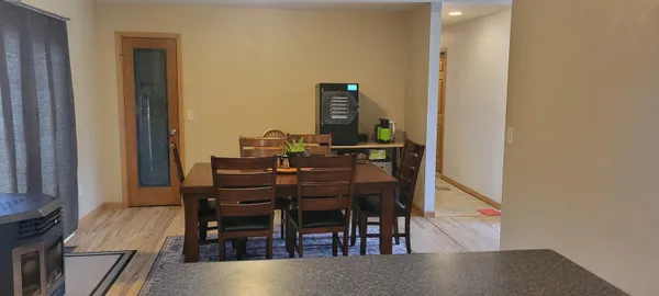 a view of a dining room with furniture and chandelier