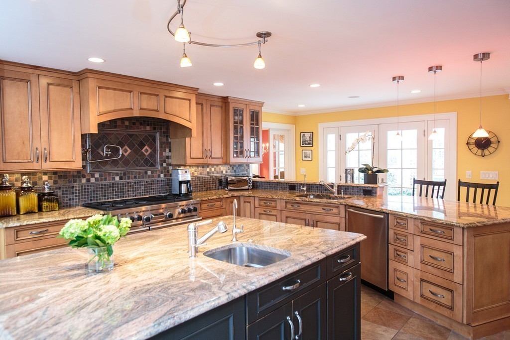61 Hundreds Road Wellesley, MA 02481 - Photo 13 of 29 a large kitchen with kitchen island granite countertop a sink a counter space and stainless steel appliances