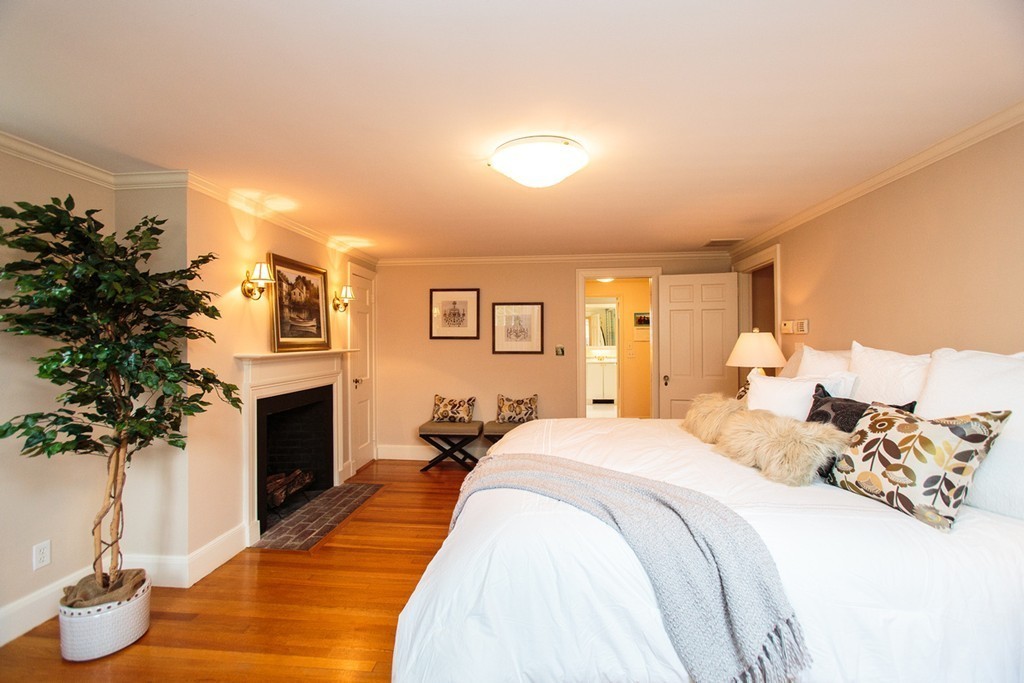 61 Hundreds Road Wellesley, MA 02481 - Photo 17 of 29 a spacious bedroom with a bed and a potted plant