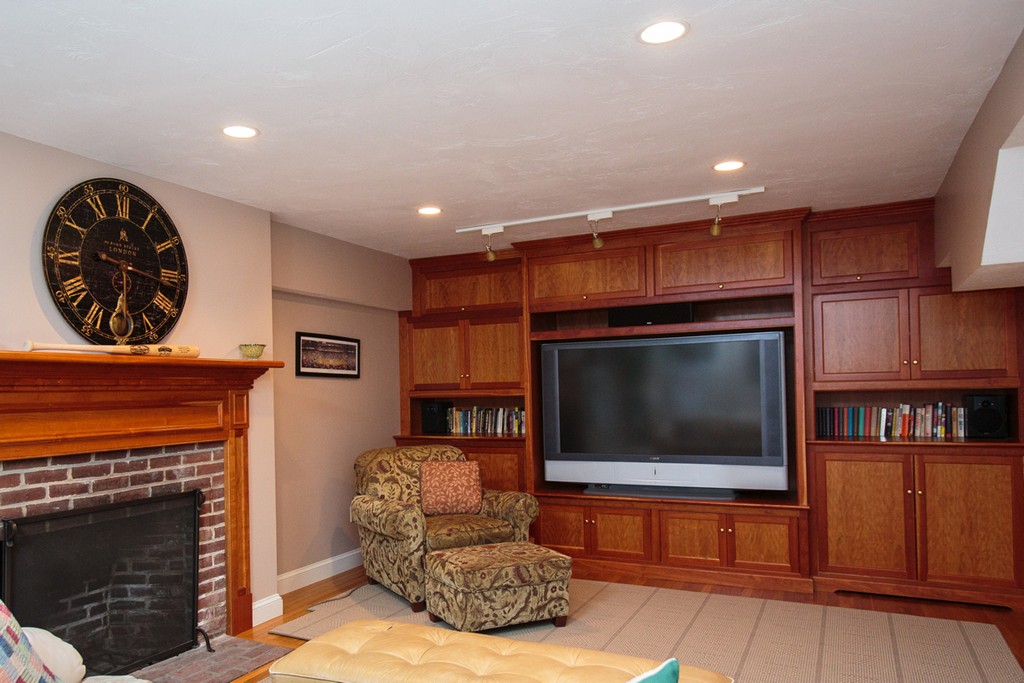 61 Hundreds Road Wellesley, MA 02481 - Photo 24 of 29 a living room with furniture a flat screen tv and a fireplace