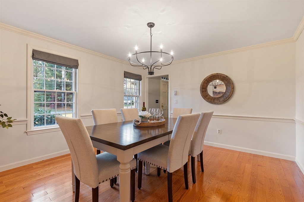 26 Bayberry Road Groton, MA 01450 - Photo 15 of 34 a view of a dining room with furniture a chandelier and wooden floor
