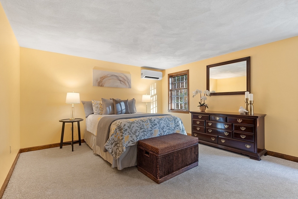 26 Bayberry Road Groton, MA 01450 - Photo 20 of 34 a bedroom with a bed and lamp