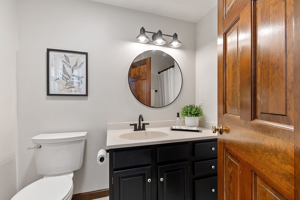 26 Bayberry Road Groton, MA 01450 - Photo 22 of 34 a bathroom with a toilet a sink and mirror