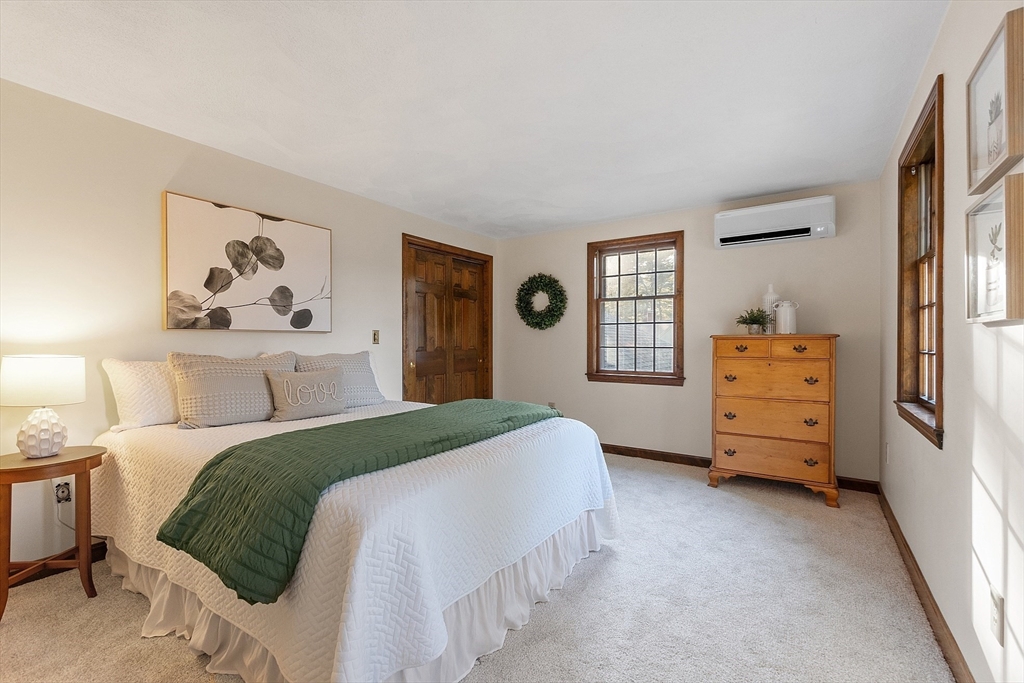 26 Bayberry Road Groton, MA 01450 - Photo 24 of 34 a bedroom with a bed and wooden floor