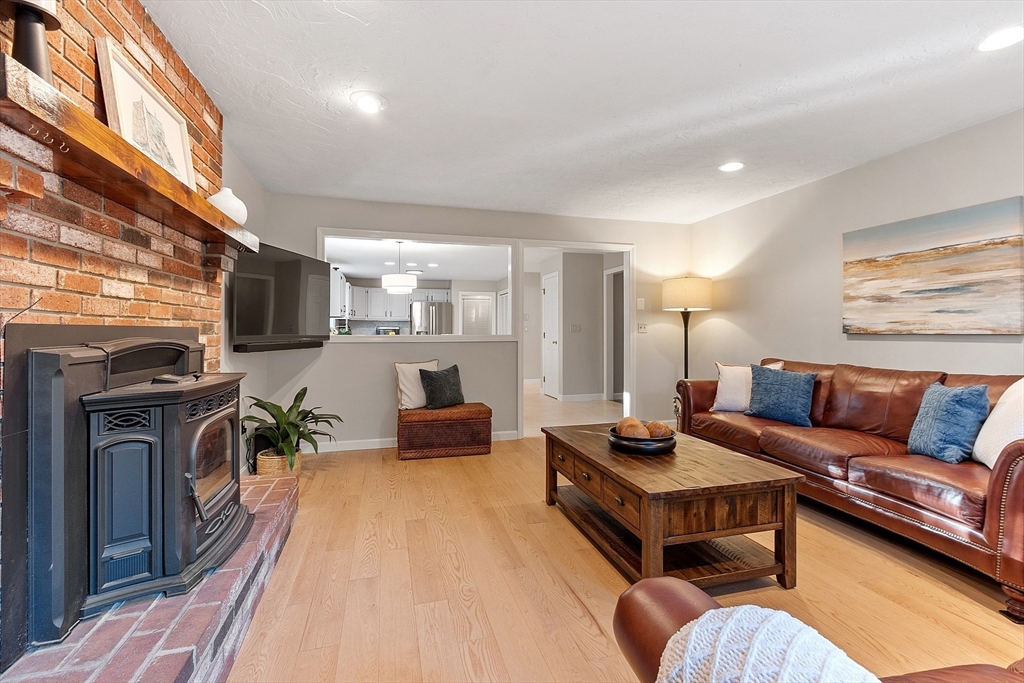 26 Bayberry Road Groton, MA 01450 - Photo 10 of 34 a living room with furniture a flat screen tv and kitchen view