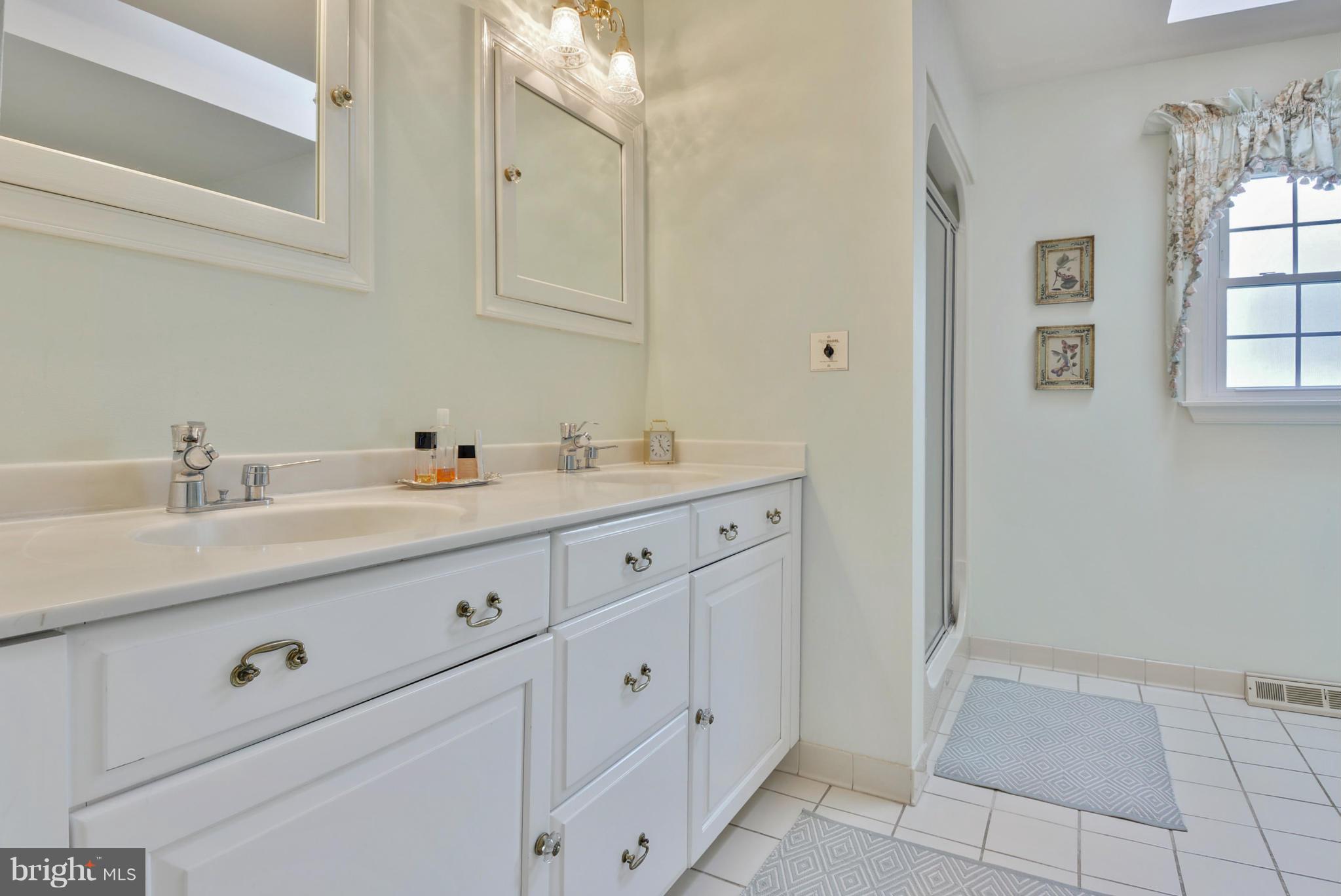 5615 Patterson Road Baldwin, MD 21013 - Photo 14 of 26 a bathroom with a double vanity sink a mirror and with