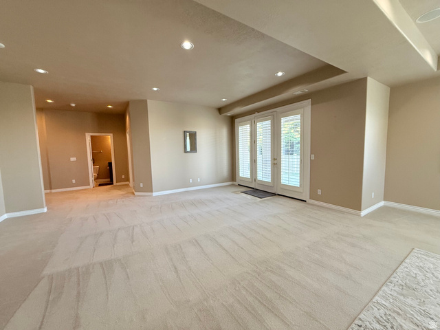 1562 Fairway Ridge Road Draper, UT 84020 - Photo 43 of 60 Spacious room featuring neutral carpeting, recessed ceiling lighting, and a tray ceiling detail