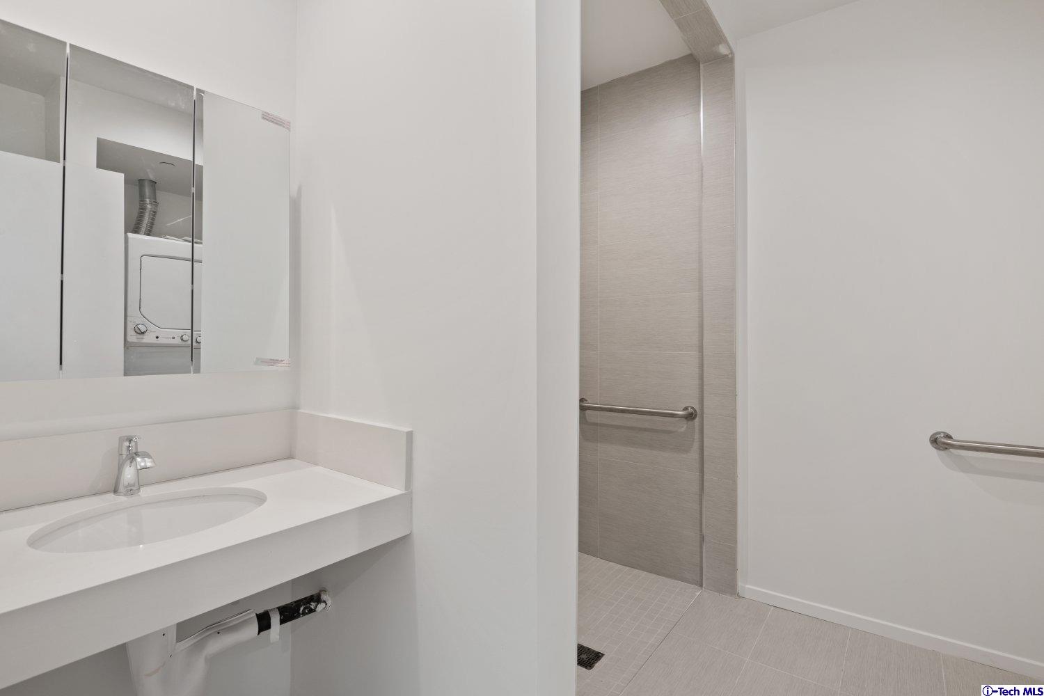 7064 Greeley Street, Unit 203 Tujunga, CA 91042 - Photo 26 of 42 a bathroom with a sink and a mirror