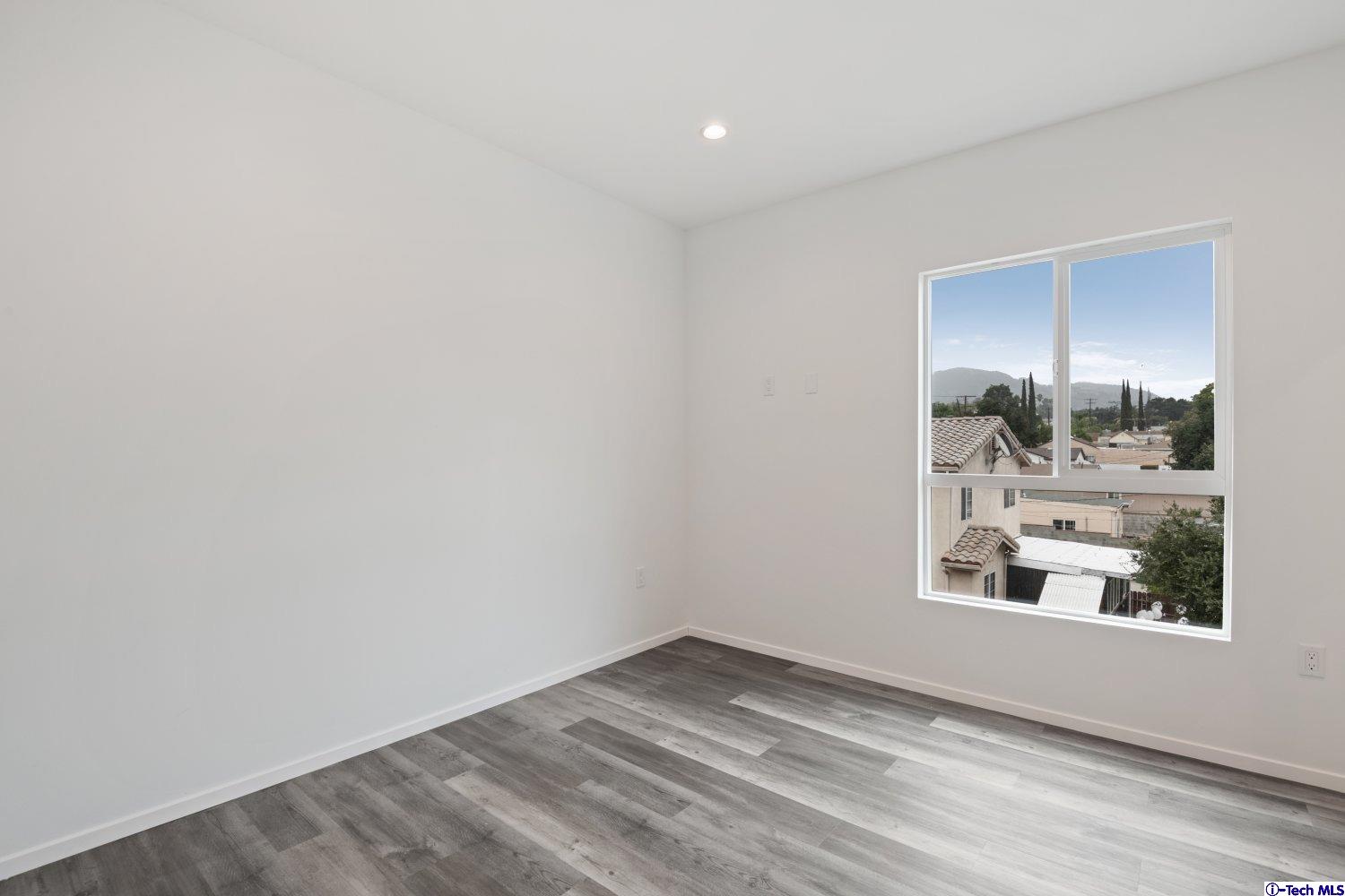 7064 Greeley Street, Unit 203 Tujunga, CA 91042 - Photo 28 of 42 a view of empty room with window