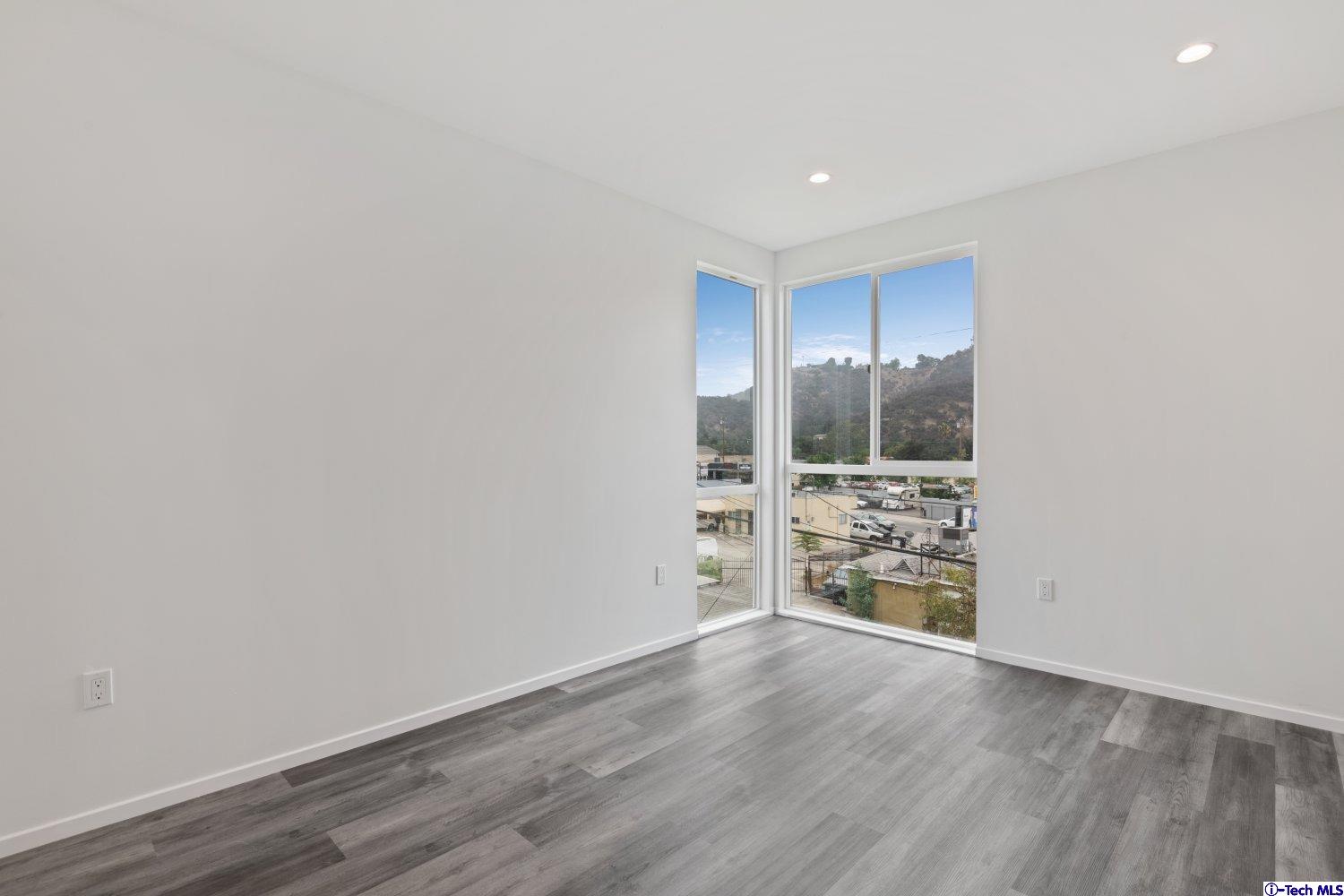 7064 Greeley Street, Unit 203 Tujunga, CA 91042 - Photo 31 of 42 a view of empty room with wooden floor