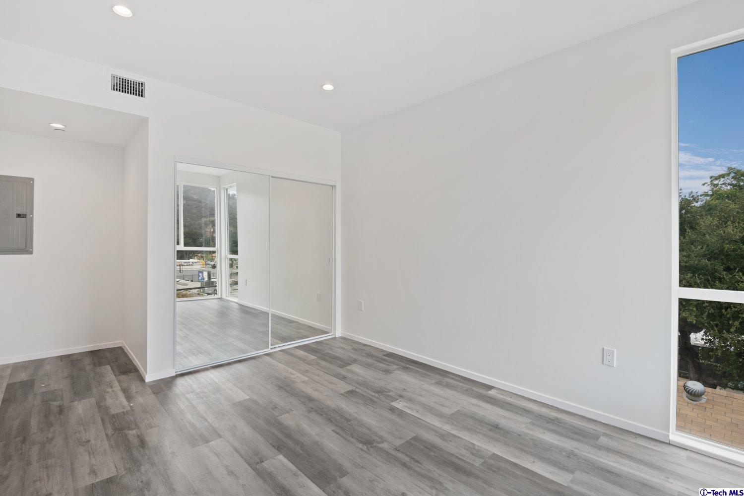 7064 Greeley Street, Unit 203 Tujunga, CA 91042 - Photo 32 of 42 wooden floor in an empty room