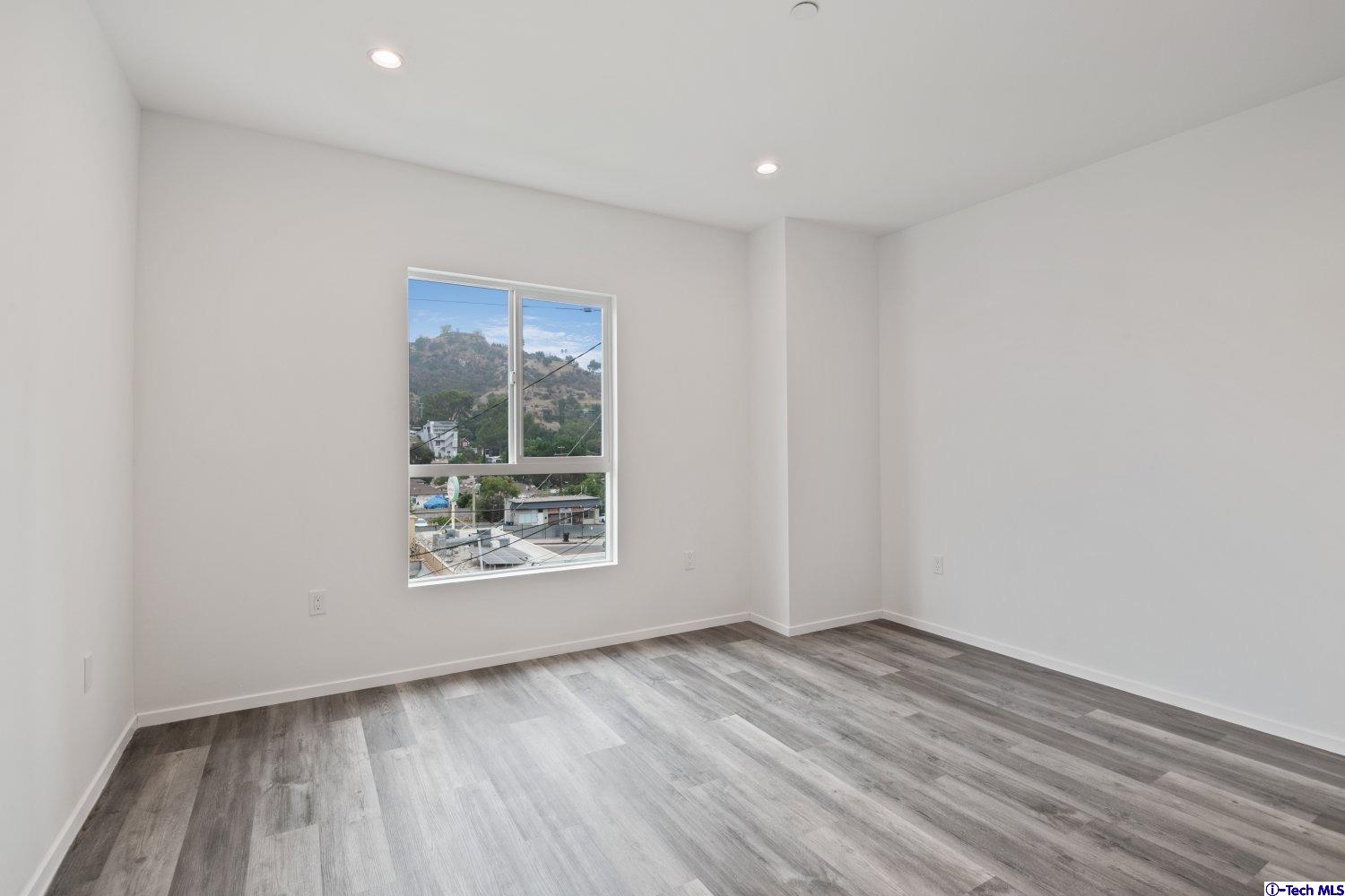 7064 Greeley Street, Unit 203 Tujunga, CA 91042 - Photo 34 of 42 wooden floor in an empty room with a window
