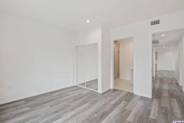 a view of a house with a yard and potted plants