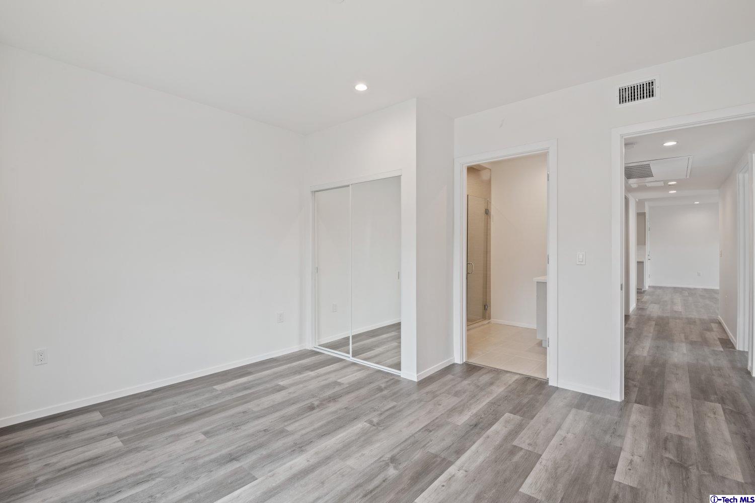 7064 Greeley Street, Unit 203 Tujunga, CA 91042 - Photo 35 of 42 a view of empty room with wooden floor