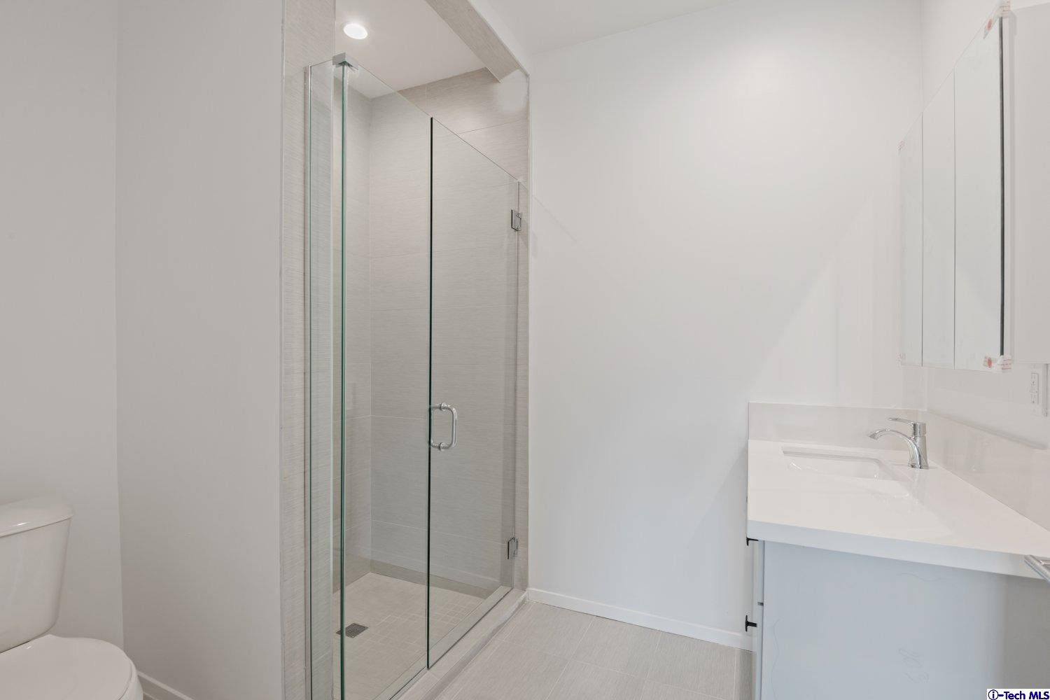 7064 Greeley Street, Unit 203 Tujunga, CA 91042 - Photo 37 of 42 a bathroom with a sink and mirror