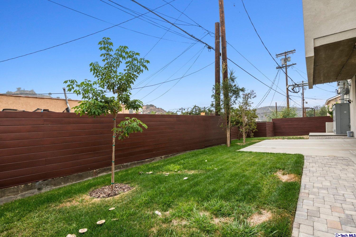 7064 Greeley Street, Unit 203 Tujunga, CA 91042 - Photo 41 of 42 a view of a backyard with potted plants