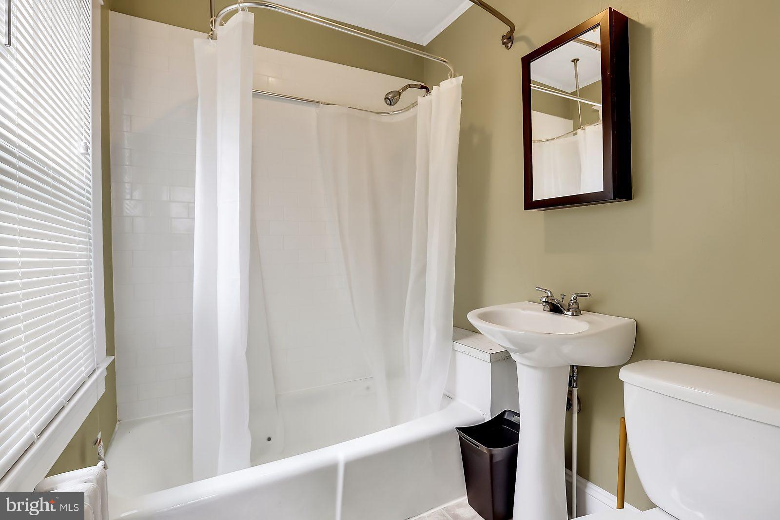 3525 St James Road Windsor Mill, MD 21244 - Photo 12 of 27 a bathroom with a sink a toilet and shower