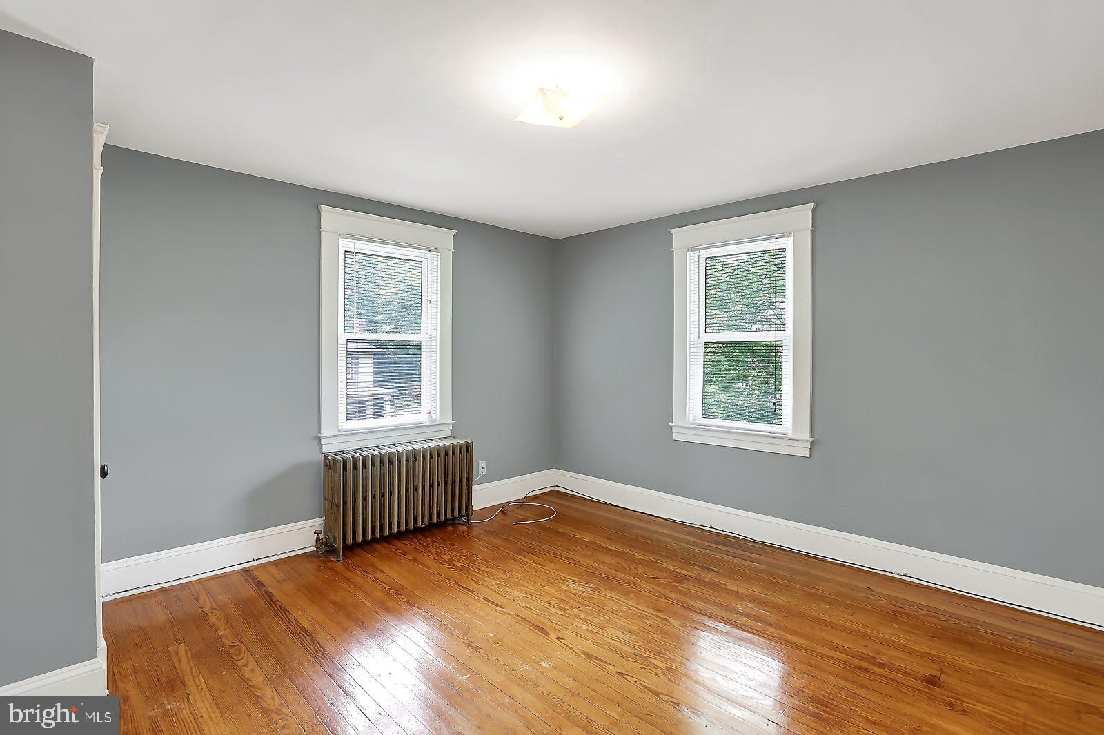 3525 St James Road Windsor Mill, MD 21244 - Photo 13 of 27 an empty room with wooden floor and windows