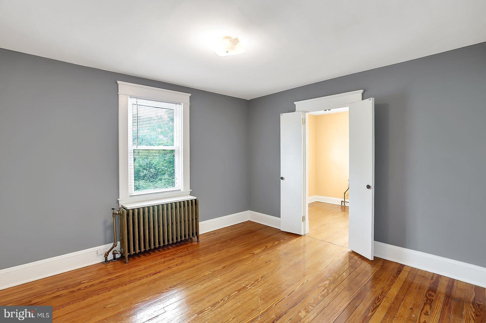 3525 St James Road Windsor Mill, MD 21244 - Photo 17 of 27 an empty room with wooden floor and a window