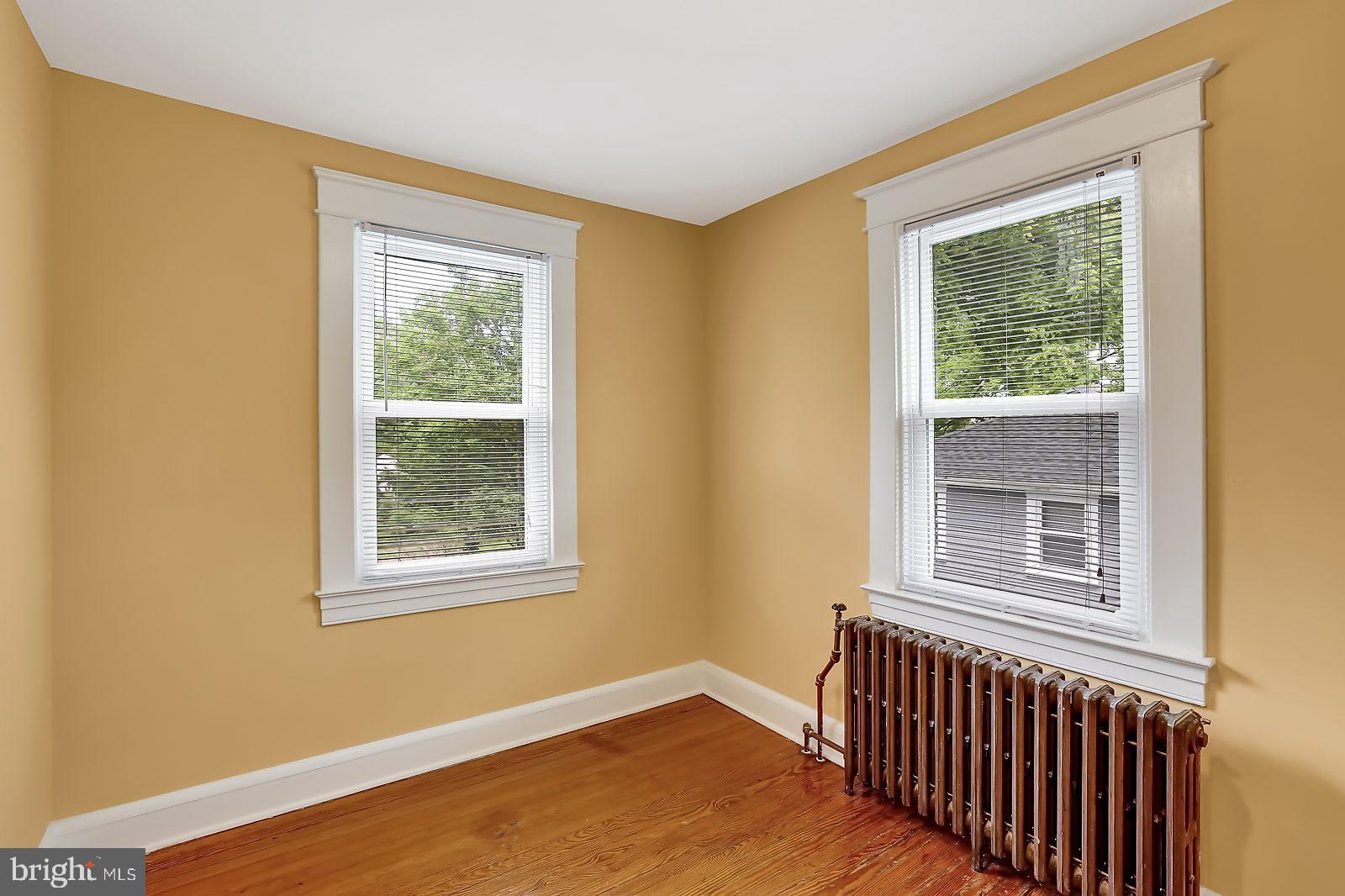 3525 St James Road Windsor Mill, MD 21244 - Photo 19 of 27 a view of an empty room with wooden floor and a window