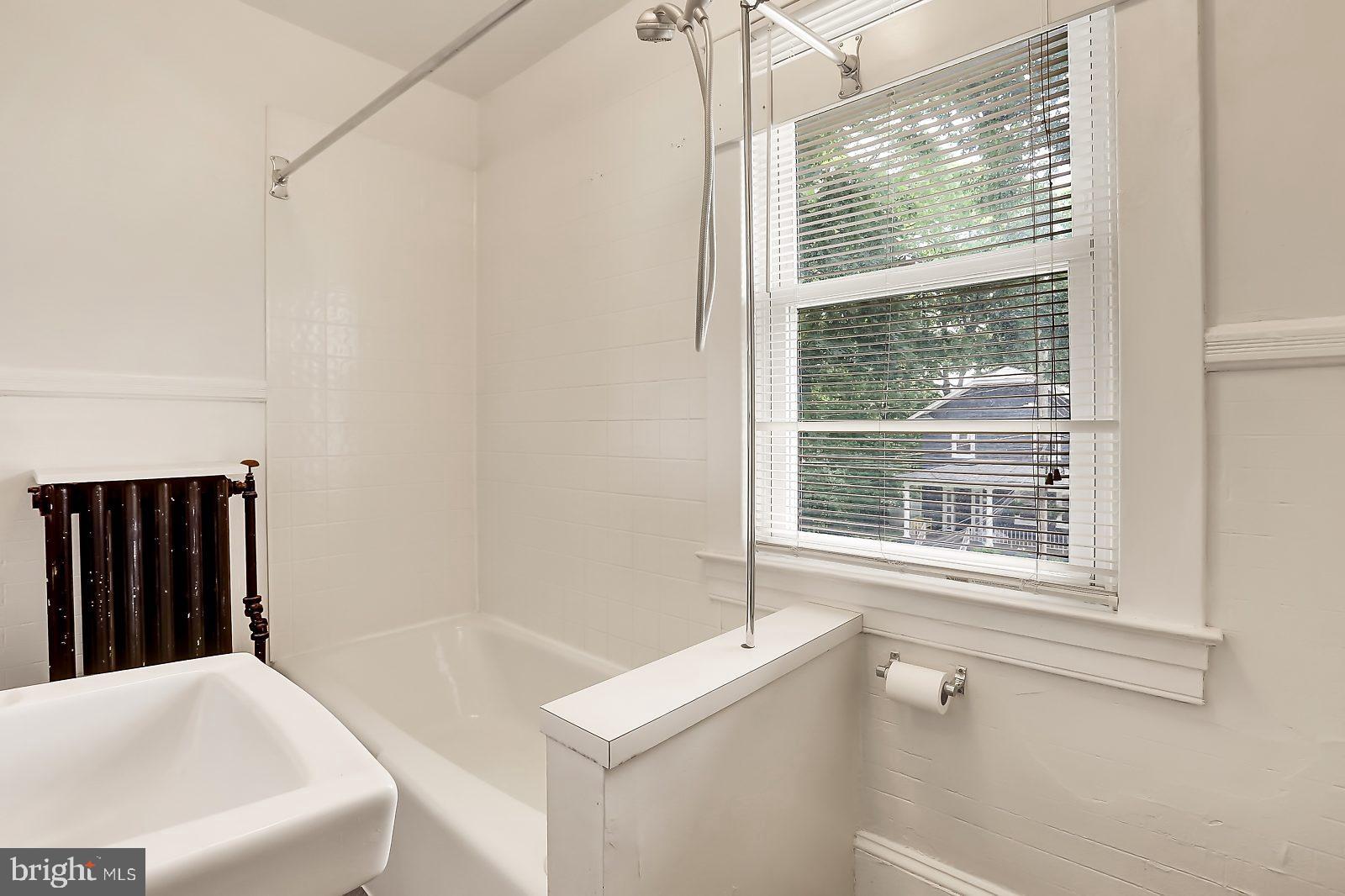 3525 St James Road Windsor Mill, MD 21244 - Photo 20 of 27 a bathroom with a tub a sink and a window