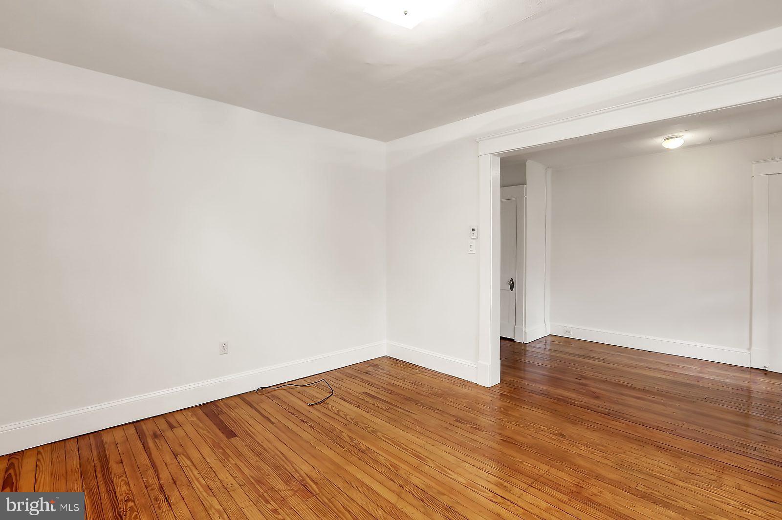 3525 St James Road Windsor Mill, MD 21244 - Photo 5 of 27 a view of an empty room with wooden floor