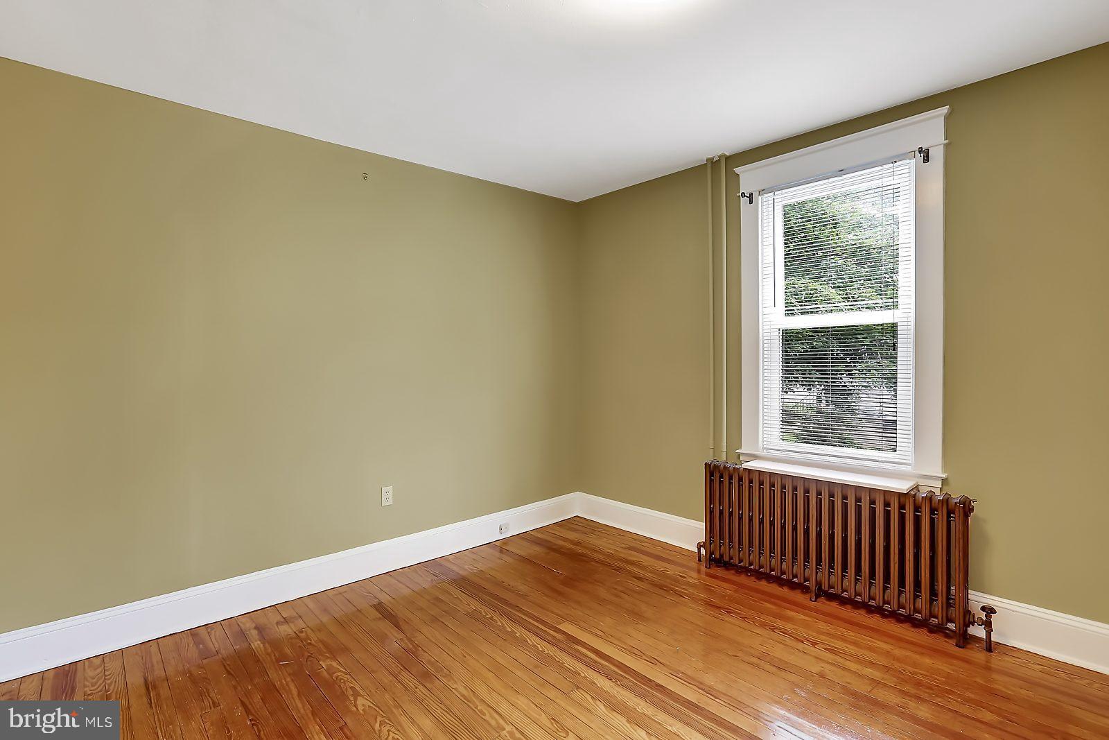 3525 St James Road Windsor Mill, MD 21244 - Photo 9 of 27 a view of an empty room with wooden floor and a window