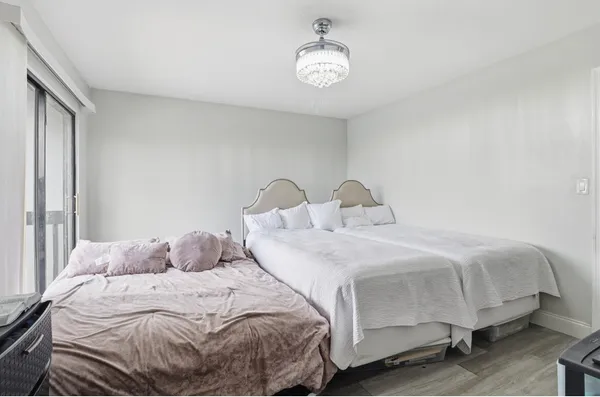 a bedroom with a bed and a chandelier