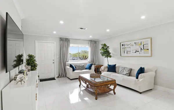 a living room with furniture potted plant and a window