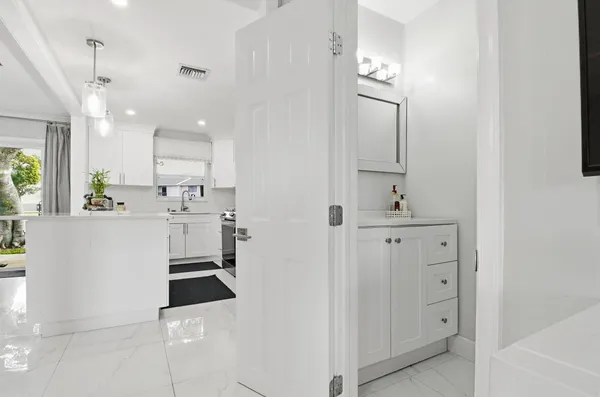 a bathroom with a sink a toilet and mirror