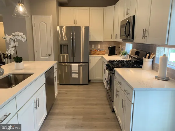 a kitchen with a sink a stove and refrigerator