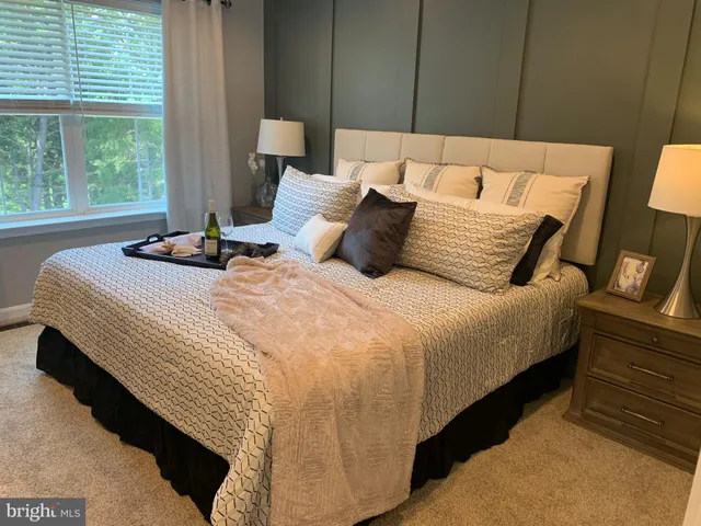 a bedroom with bed and window