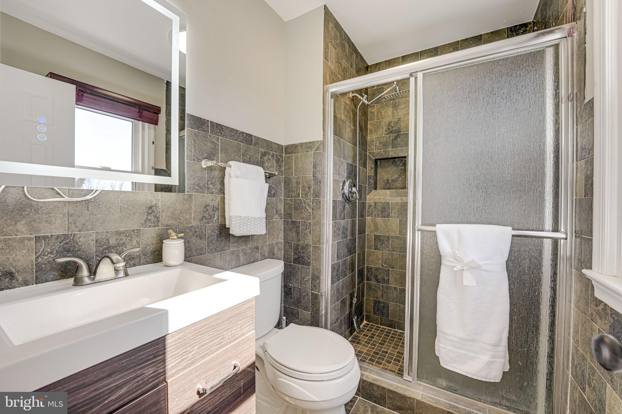 7829 Richfield Road Springfield, VA 22153 - Photo 18 of 34 a bathroom with a sink toilet and shower