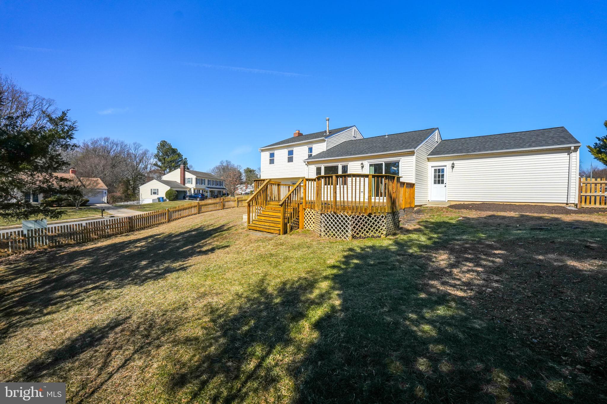 7829 Richfield Road Springfield, VA 22153 - Photo 32 of 34 a big yard with large trees and buildings in the background