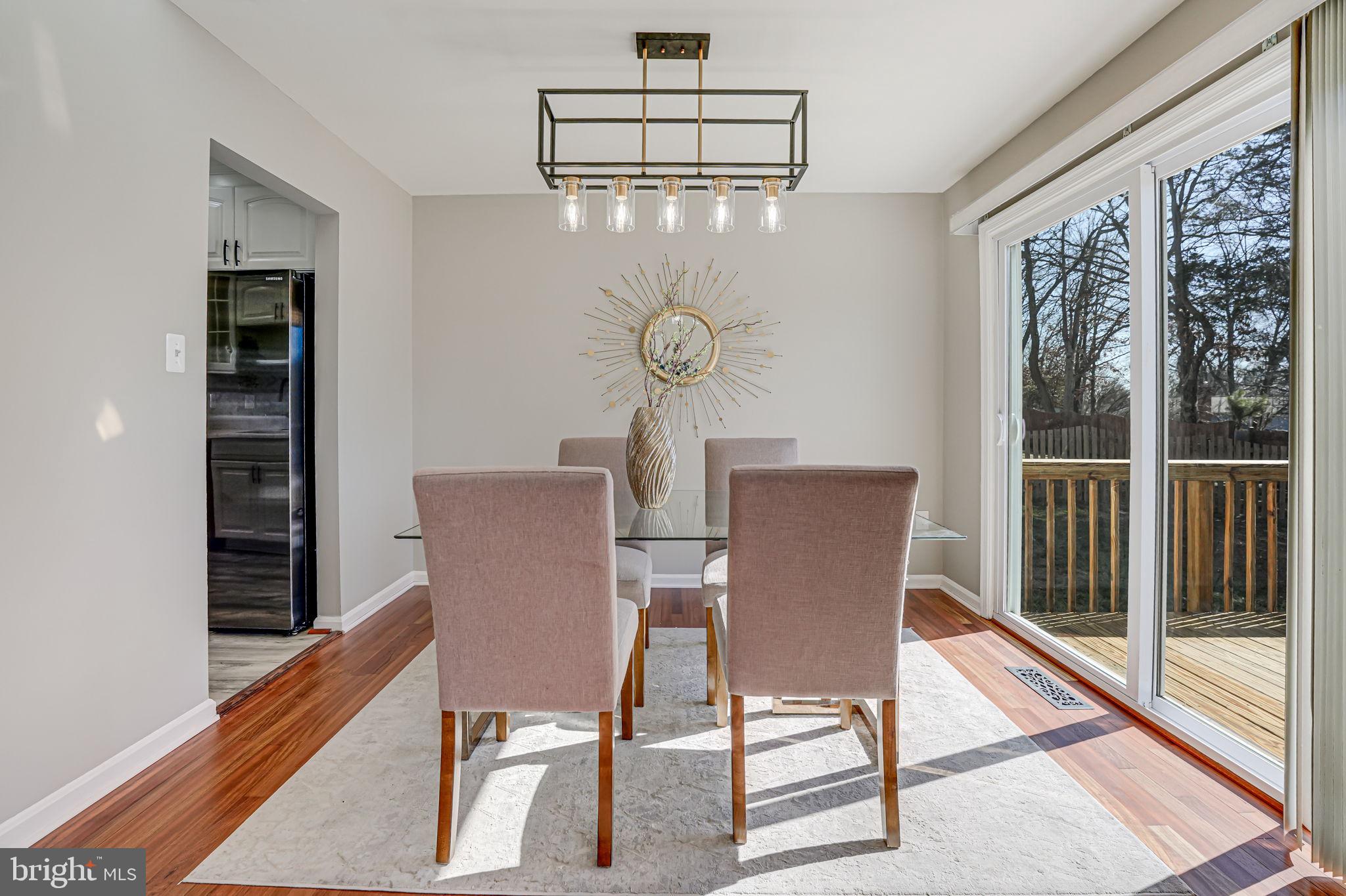 7829 Richfield Road Springfield, VA 22153 - Photo 9 of 34 a view of a dining room with furniture wooden floor and a chandelier