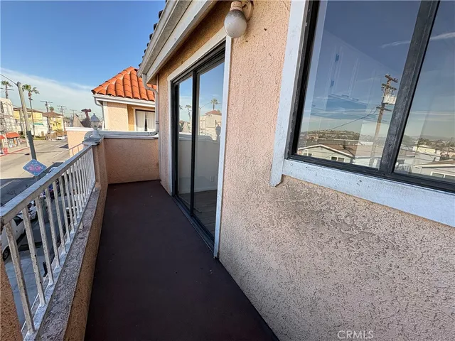 a view of a balcony with wooden floor and stairs