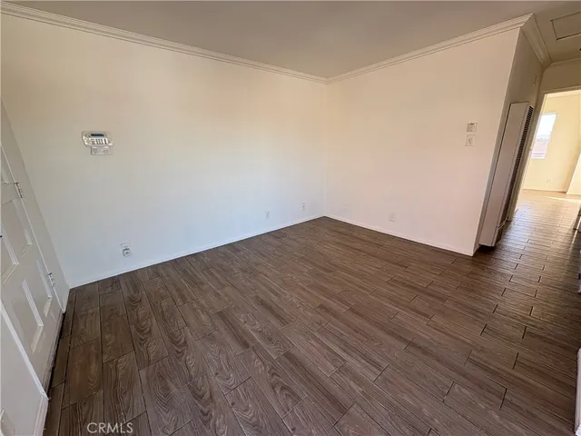 a view of a room with wooden floor