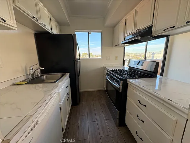 a kitchen with cabinets and appliances
